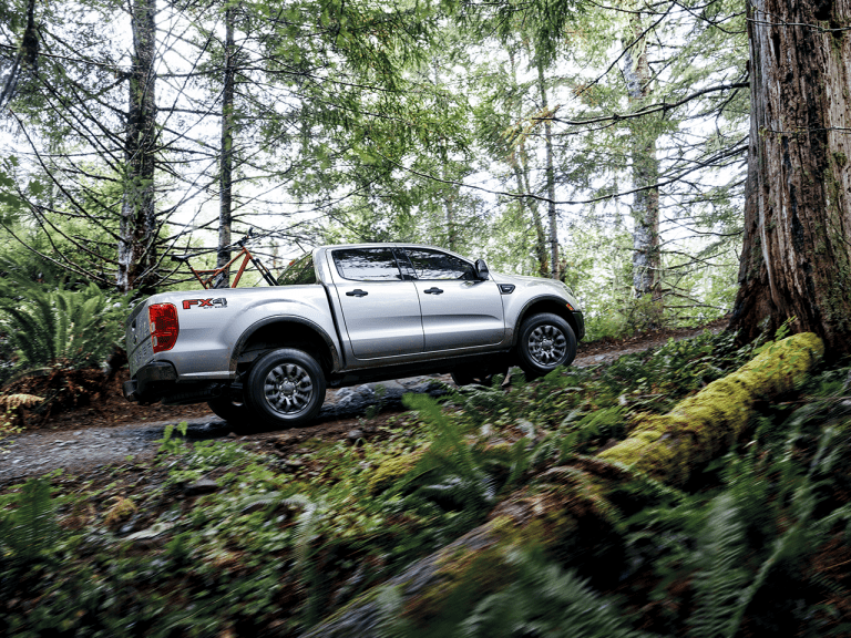 best small truck in canada driving through a forest