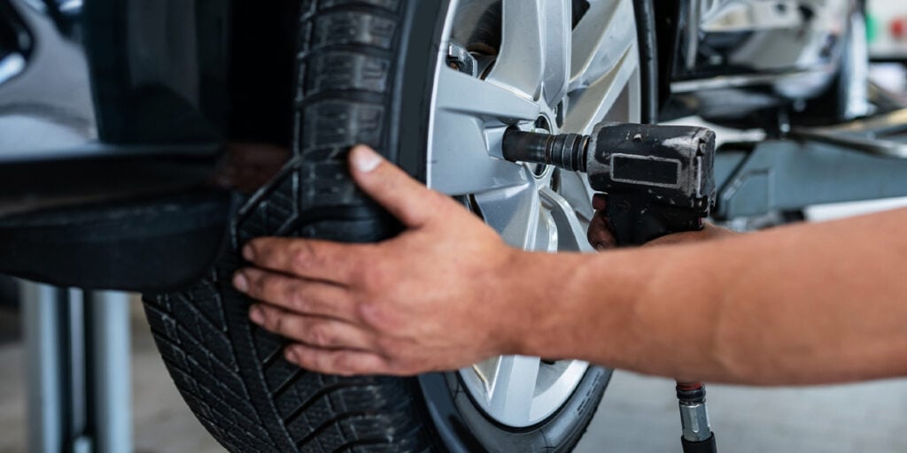 Installing a new tire at a tire shop in winnipeg