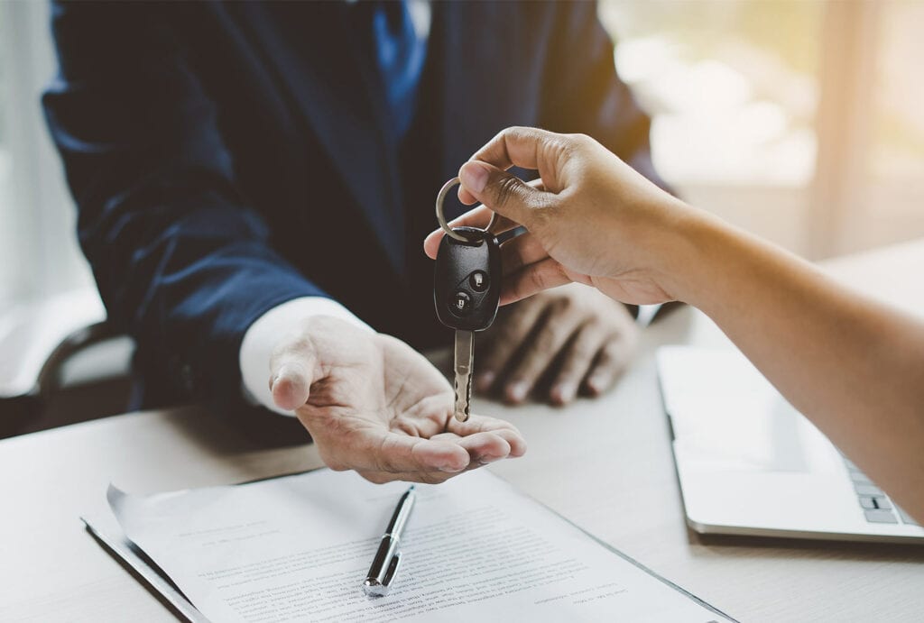 image of customer hand handing keys to product advisor hand