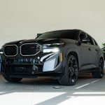 Black 2025 BMW XM sitting in bright showroom