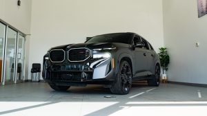 Black 2025 BMW XM sitting in bright showroom