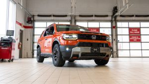 orange 2026 honda passport in service bay