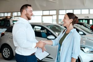 salesman and customer shaking hands in showroom