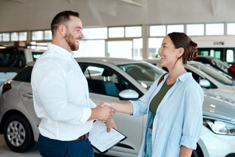 salesman and customer shaking hands in showroom