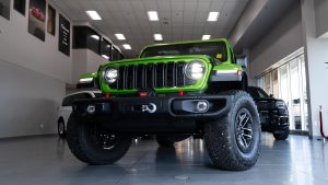 Bright green 2025 jeep wrangler rubicon in showroom
