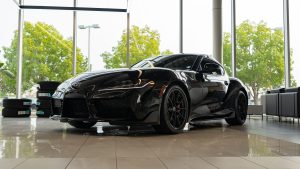 black 2026 Toyota supra sitting in bright showroom