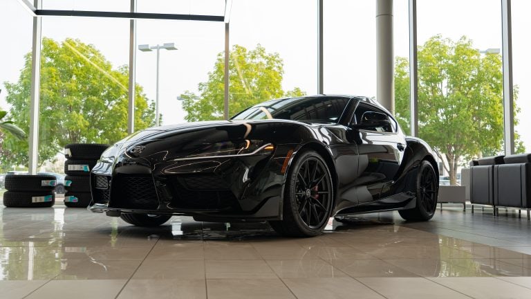 black 2026 Toyota supra sitting in bright showroom