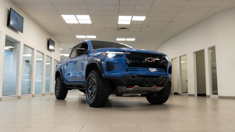 blue 2025 Chevrolet Colorado parked in bright showroom