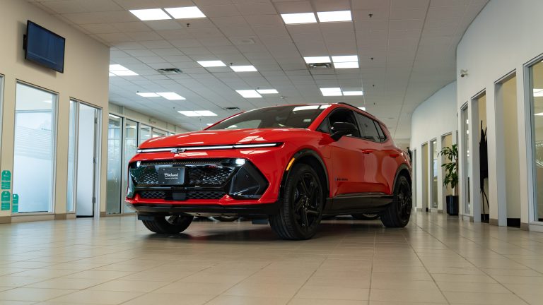 red 2025 chevrolet equinox ev sitting in showroom