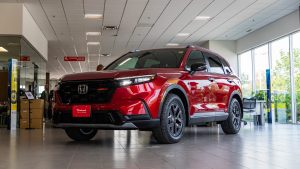 red 2026 honda cr-v trailsport hybrid sitting in showroom