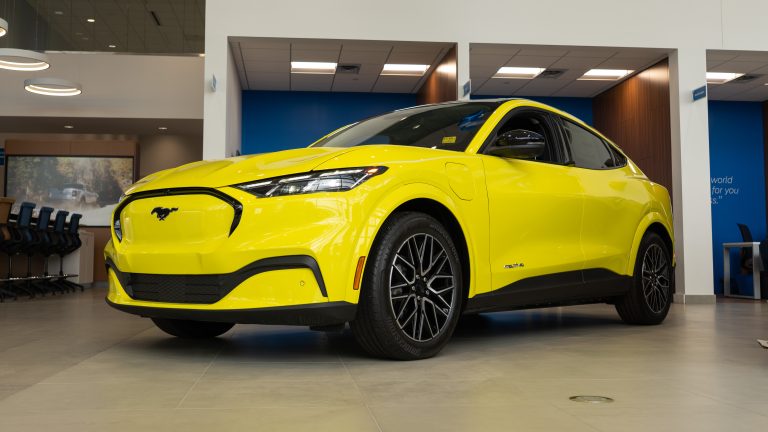 yellow ford mustang machE in showroom