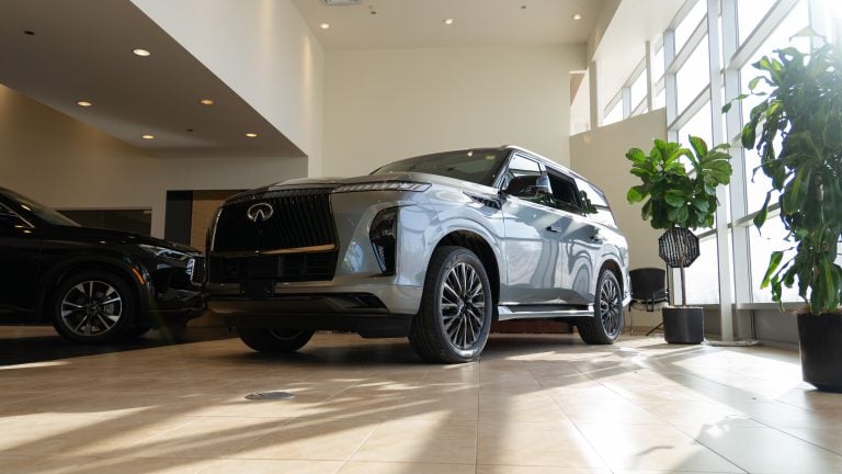 Grey 2026 Infiniti QX80 sitting in bright showroom