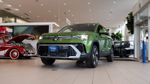green 2026 Volkswagen Taos sitting in showroom