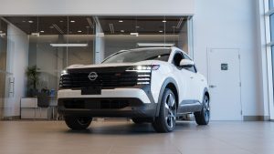 white 2025 nissan kicks in bright showroom
