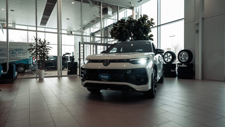 white 2026 Volkswagen Tiguan parked in dealership showroom