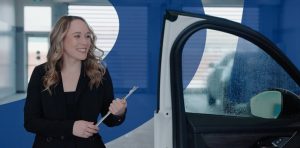 service advisor walking around vehicle with door open