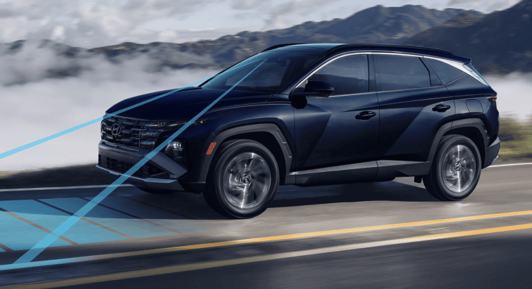 2026 Tucson driving on highway with lane assist feature shown