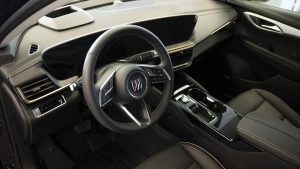 interior shot of a buick envision, highlighting the entire dashboard including touchscreen and steering wheel