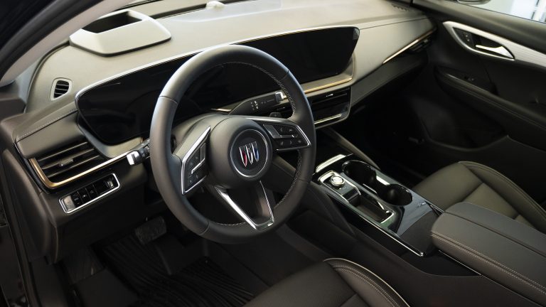 interior shot of a buick envision, highlighting the entire dashboard including touchscreen and steering wheel