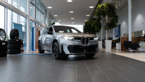 silver bmw iX3 parked in showroom